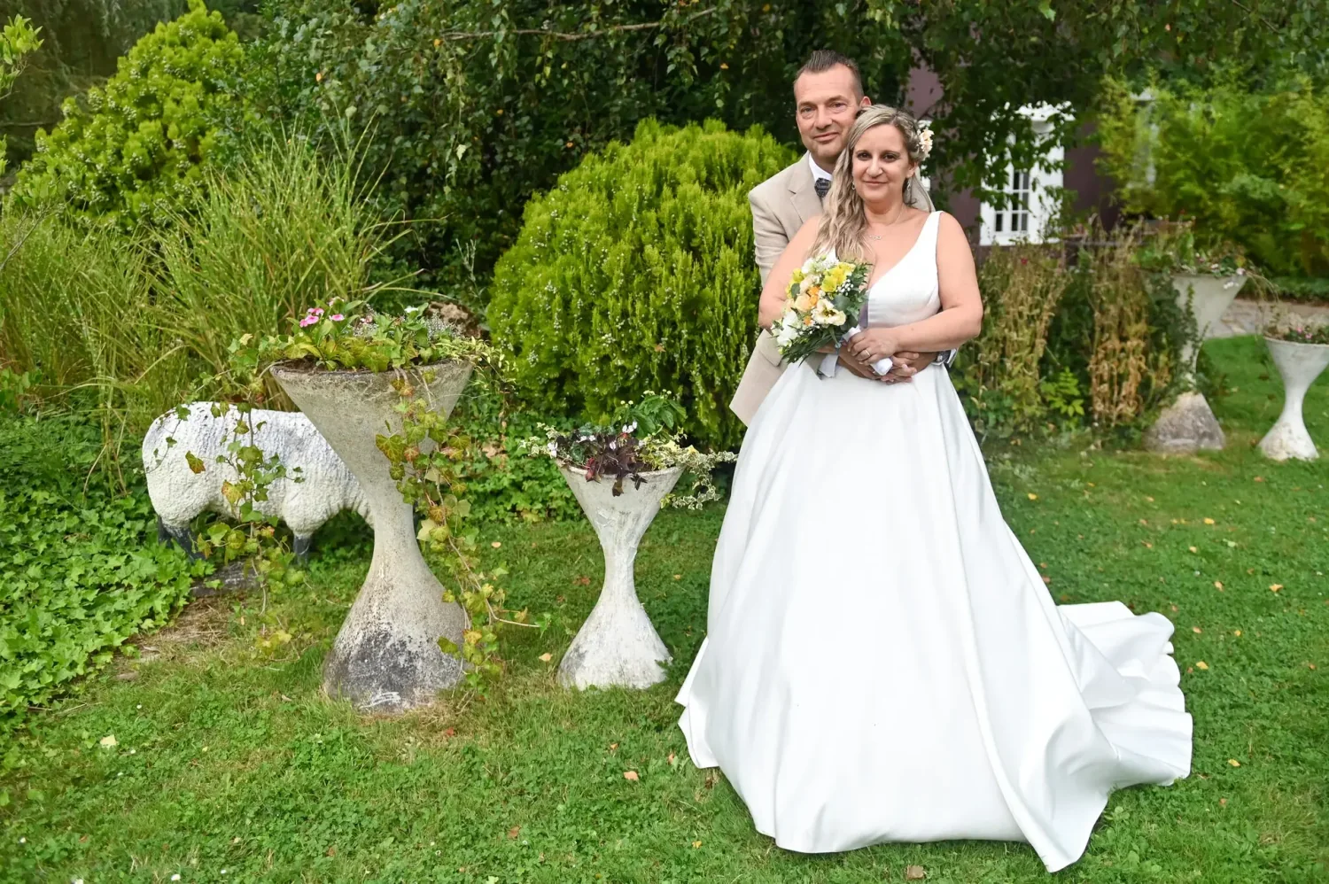 Mariés debout dans un jardin fleuri, reportage de mariage