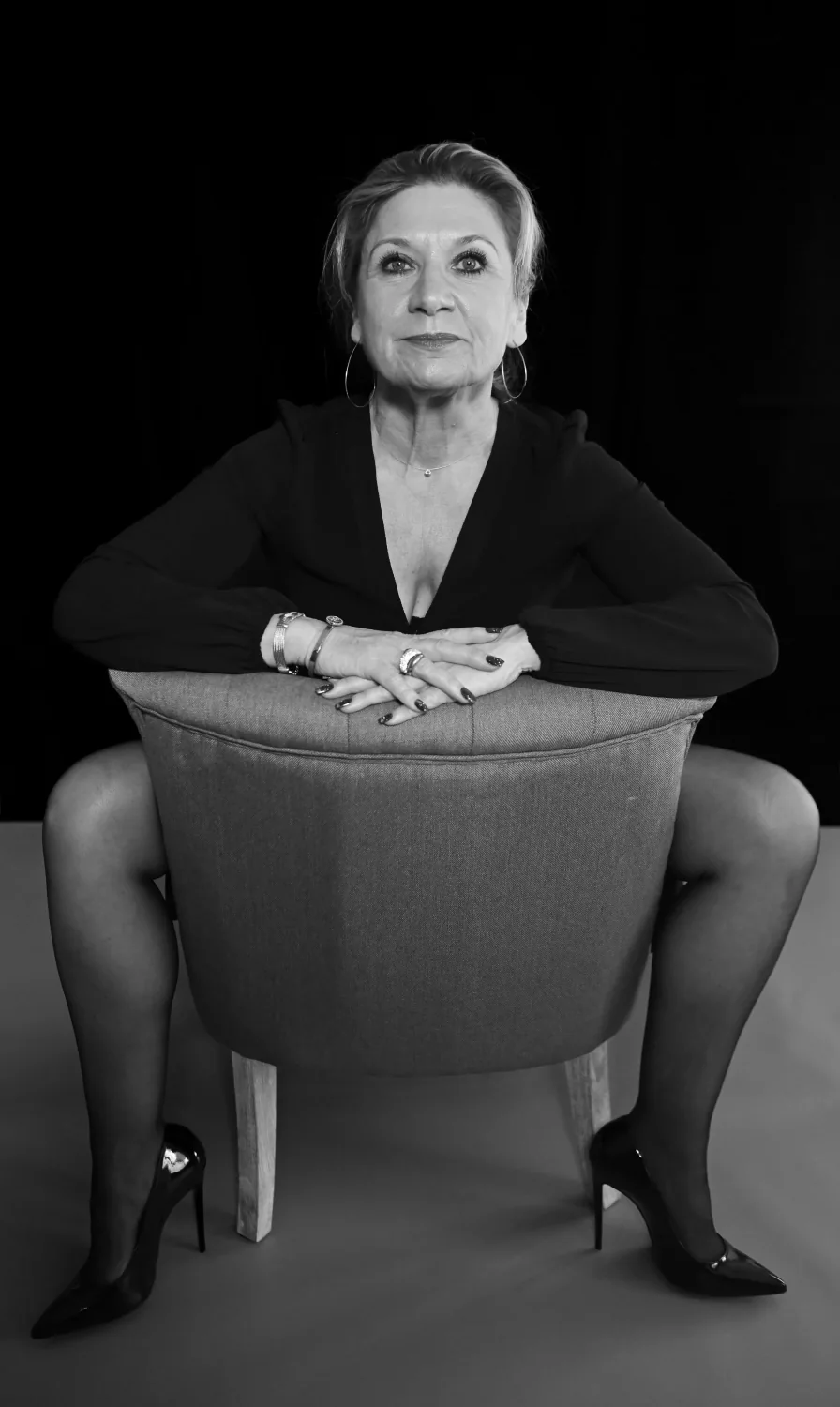 Portrait de femme assise sur une chaise, en noir et blanc